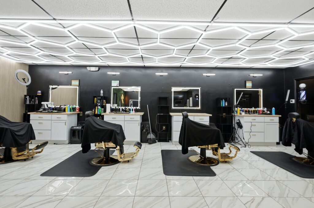 Row of barber chairs and lit mirrors at Golden Barbershop in Martinsburg, West Virginia.