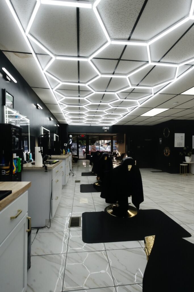 View down the barber stations and product counter at Golden Barbershop.