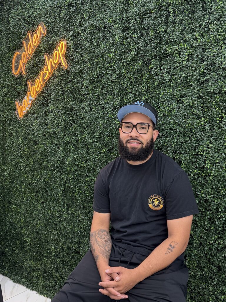 Drue, barber at Golden Barbershop.