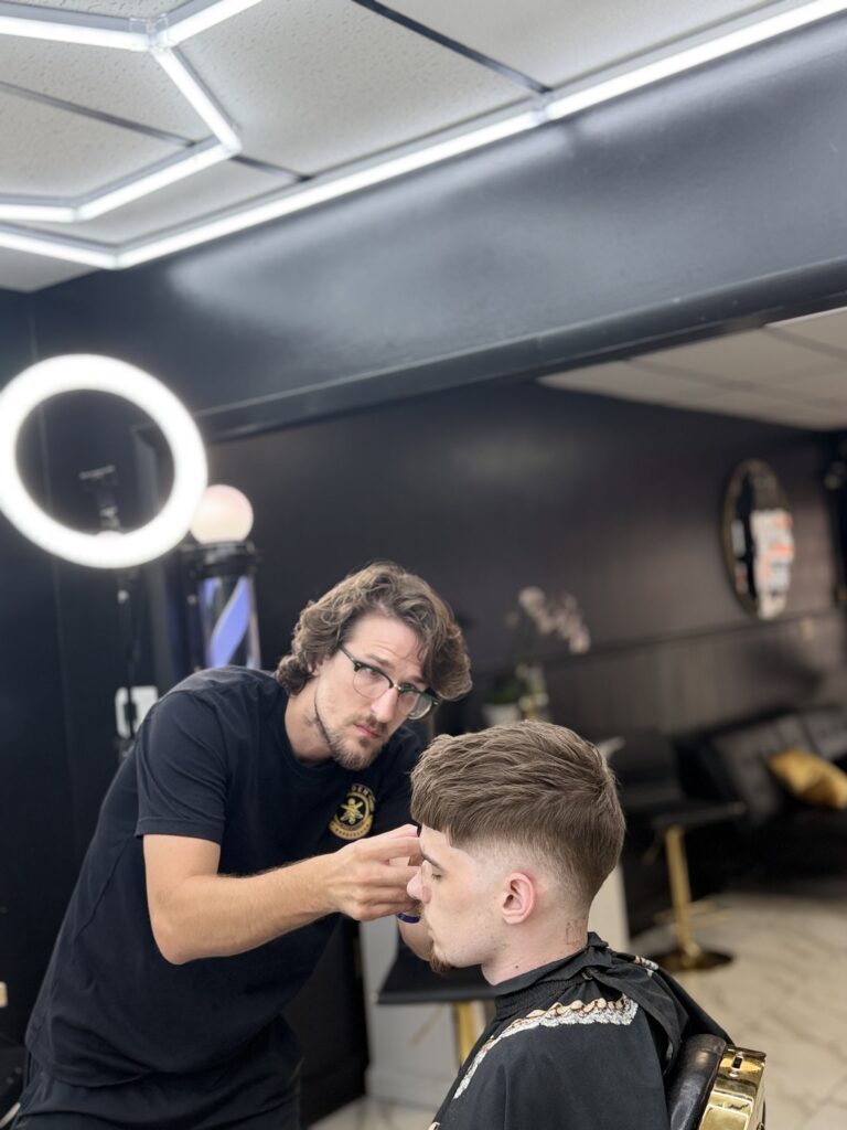 Christopher James, barber at Golden Barbershop.